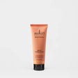Sukin Brightening Jelly Exfoliator in a peach-colored tube with black cap.