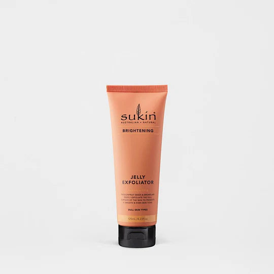 Sukin Brightening Jelly Exfoliator in a peach-colored tube with black cap.