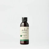 Sukin Signature Cleansing Oil in a dark amber bottle with cap.
