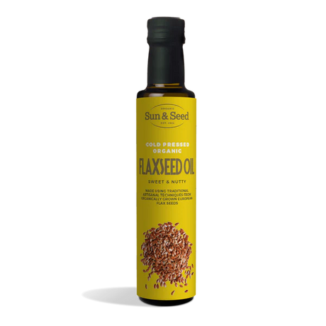 Tall dark glass bottle of Sun & Seed Cold Pressed Organic Flaxseed Oil featuring a bright yellow label with an illustration of flaxseeds at the bottom.