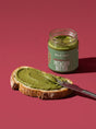 Small glass jar of Sun & Seed Pumpkin Seed Butter with gold lid and green label.