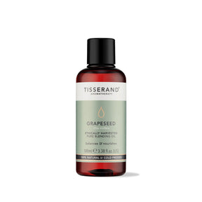 100ml amber glass bottle of Tisserand Grapeseed oil with a sage green and white label and a black screw cap.
