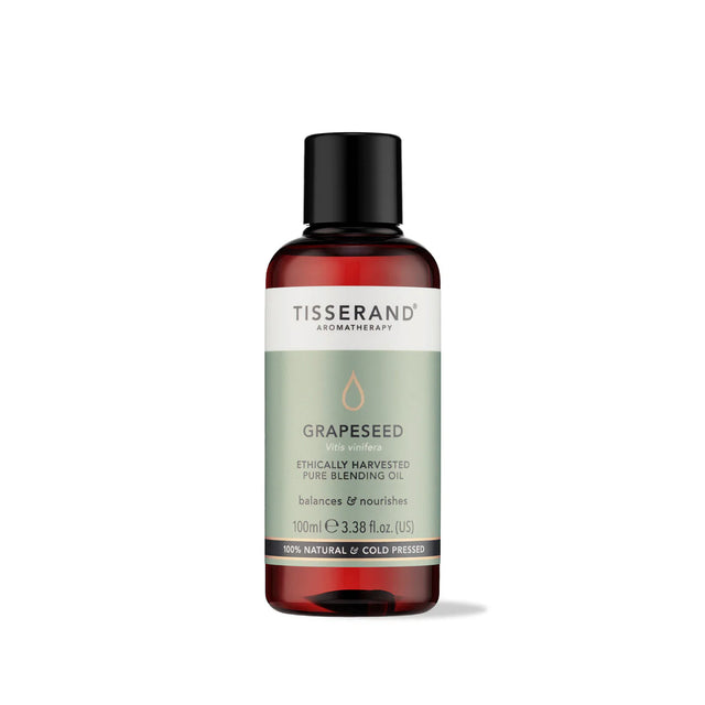 100ml amber glass bottle of Tisserand Grapeseed oil with a sage green and white label and a black screw cap.