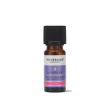 A small amber glass bottle of Tisserand Lavender pure essential oil with a purple and white label and a black cap.