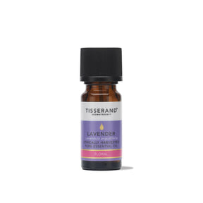 A small amber glass bottle of Tisserand Lavender ethically harvested pure essential oil with a purple, pink, and white label and a black cap.