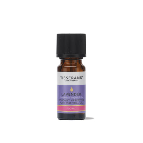 A small amber glass bottle of Tisserand Lavender ethically harvested pure essential oil with a purple, pink, and white label and a black cap.