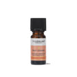 A small amber glass bottle of Tisserand May Chang ethically harvested pure essential oil with a peach and white label and a black cap.