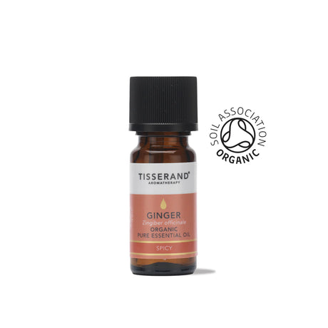 A small amber glass bottle of Tisserand Ginger organic pure essential oil with a terracotta and white label and a black cap.