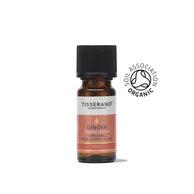 A small amber glass bottle of Tisserand Ginger organic pure essential oil with a terracotta and white label and a black cap.
