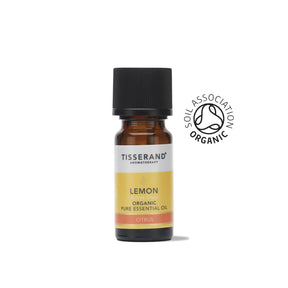 A small amber glass bottle of Tisserand Lemon organic pure essential oil with a yellow and white label and a black cap.