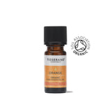 A small amber glass bottle of Tisserand Orange organic pure essential oil with an orange and white label and a black cap.