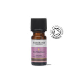 A small amber glass bottle of Tisserand Patchouli organic pure essential oil with a purple and white label and a black cap.