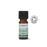 A small amber glass bottle of Tisserand Peppermint organic pure essential oil with a light green and white label and a black cap.