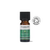 A small amber glass bottle of Tisserand Tea Tree organic pure essential oil with a green and white label and a black cap.