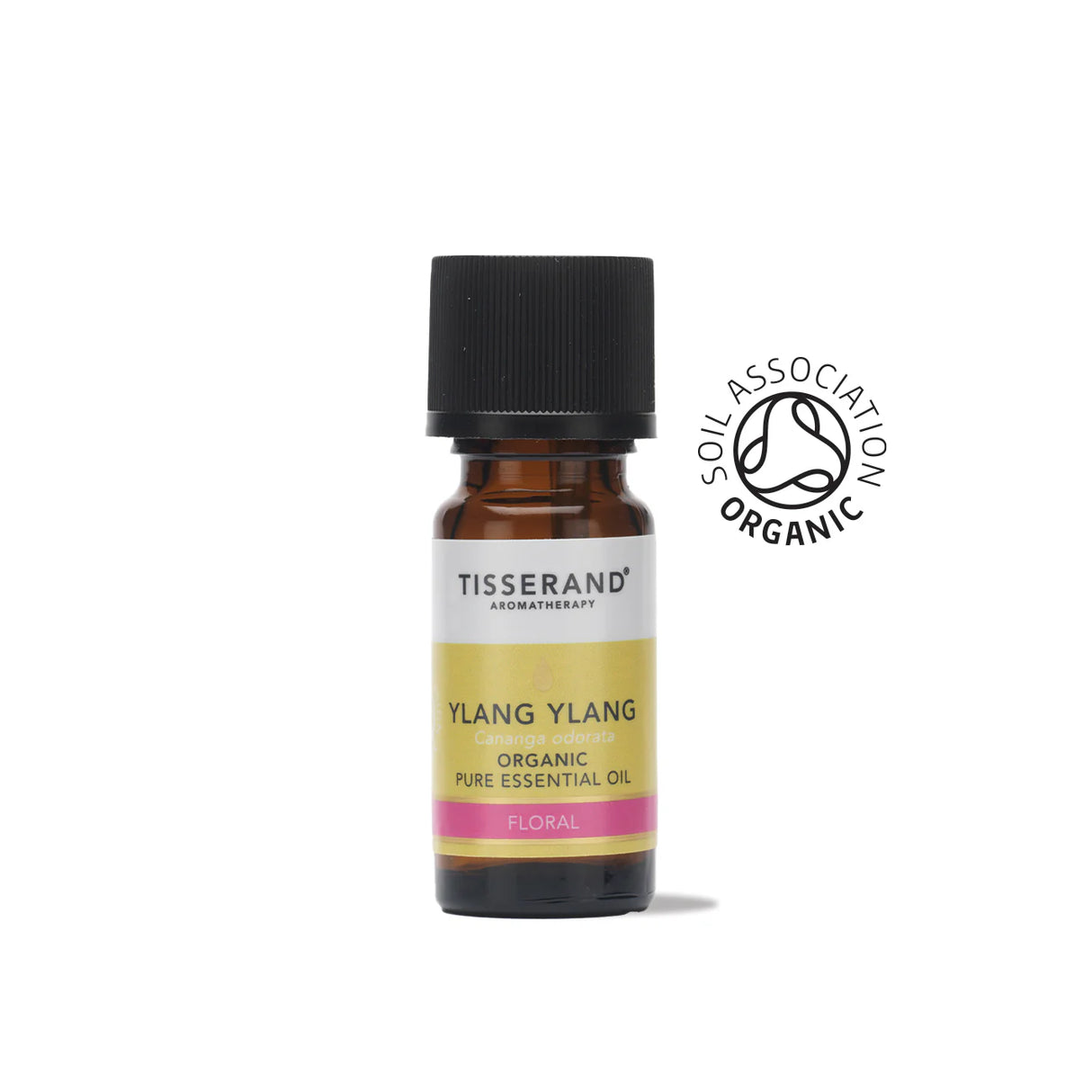 A small amber glass bottle of Tisserand Ylang Ylang organic pure essential oil with a yellow, pink, and white label and a black cap.