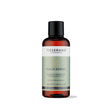 100ml amber glass bottle of Tisserand Peach Kernel oil with a sage green and white label and a black screw cap.