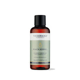 100ml amber glass bottle of Tisserand Peach Kernel oil with a sage green and white label and a black screw cap.