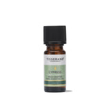 A small amber glass bottle of Tisserand Cypress wild crafted pure essential oil with a pale green and white label and a black cap.