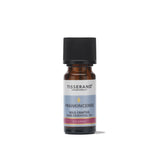 A small amber glass bottle of Tisserand Frankincense wild crafted pure essential oil with a light blue and white label and a black cap.