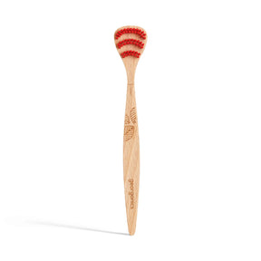 Wooden toothbrush with red bristles, featuring a carved leaf design on the handle. Branding text "georganics" is visible, conveying an eco-friendly vibe.