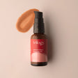 A 30ml amber glass bottle of Trilogy Instant Glow Rosehip Oil with a black pump dispenser and a vibrant red label.