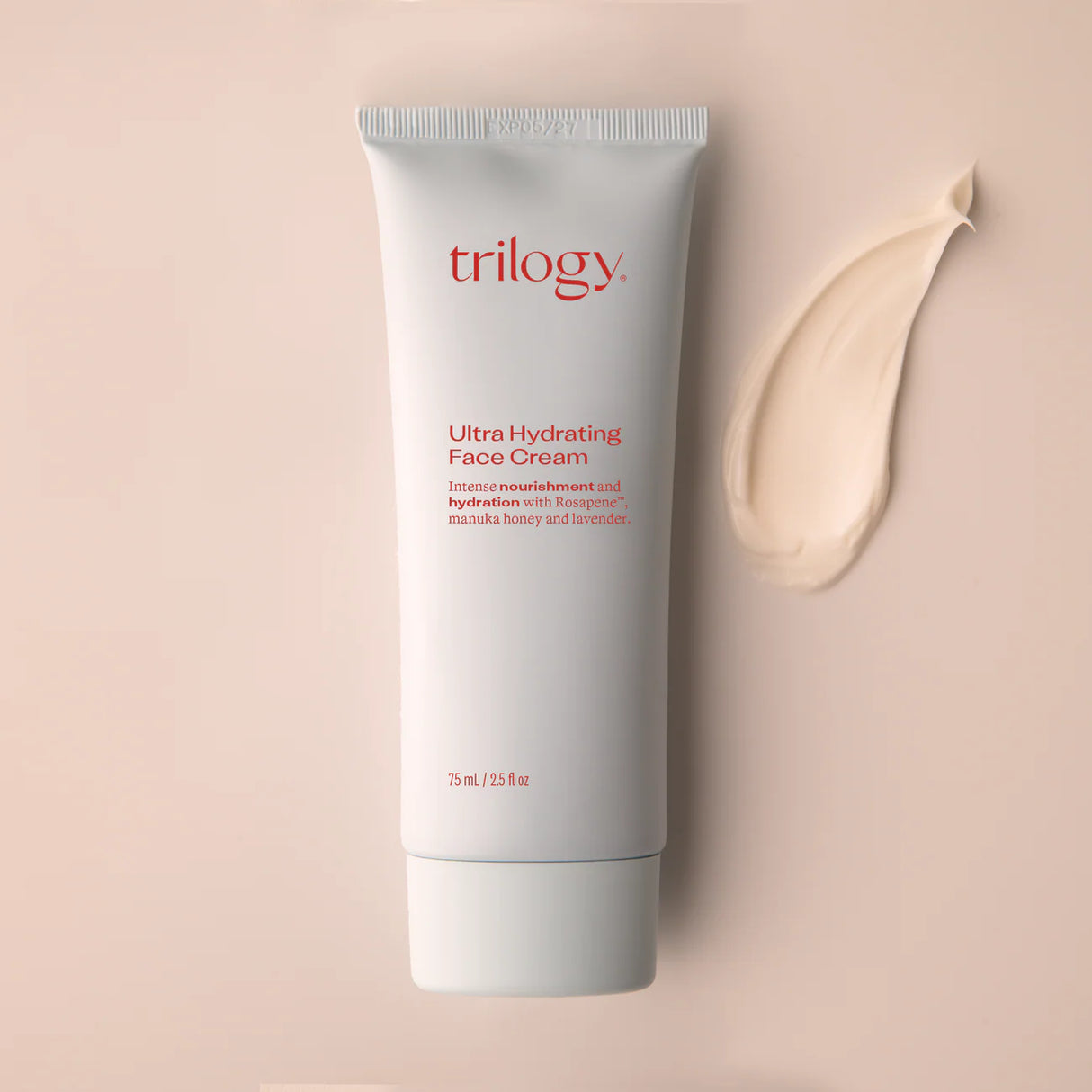 A 75ml tube of Trilogy Ultra Hydrating Face Cream in minimalist white packaging with red text, featuring Rosapene, manuka honey, and lavender.