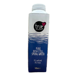 A 500ml carton of True Natural Products Pure Irish Still Spring Water, featuring a white cap, a white upper section with a blue water ripple graphic, and a dark blue lower section with white text.