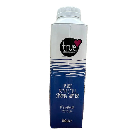A 500ml carton of True Natural Products Pure Irish Still Spring Water, featuring a white cap, a white upper section with a blue water ripple graphic, and a dark blue lower section with white text.