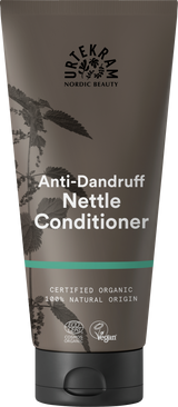 A brown tube of Urtekram Anti-Dandruff Nettle Conditioner featuring a nettle plant illustration, a teal stripe, and organic and vegan logos.
