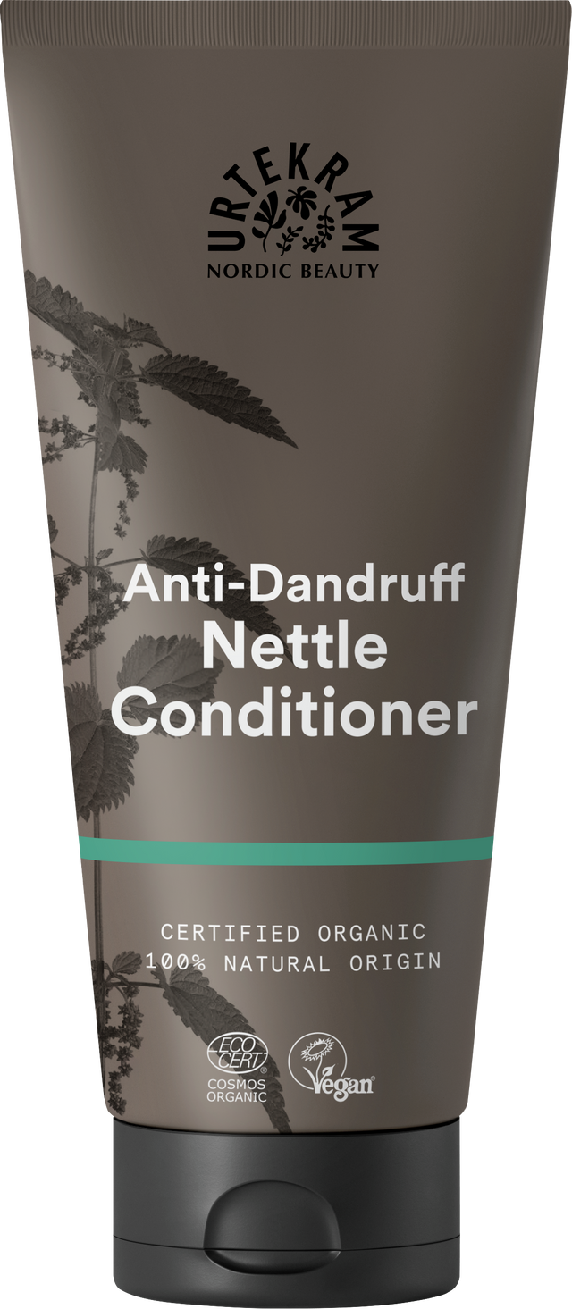 A brown tube of Urtekram Anti-Dandruff Nettle Conditioner featuring a nettle plant illustration, a teal stripe, and organic and vegan logos.