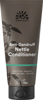 A brown tube of Urtekram Anti-Dandruff Nettle Conditioner featuring a nettle plant illustration, a teal stripe, and organic and vegan logos.