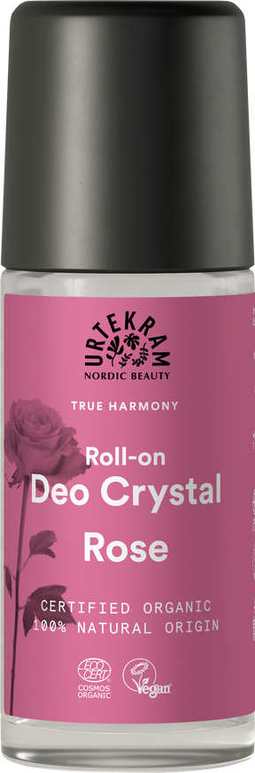 A glass roll-on deodorant bottle with a pink label featuring a rose illustration, Urtekram branding, and organic and vegan certifications.
