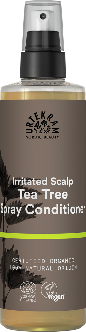 A brown spray bottle of Urtekram Tea Tree Spray Conditioner for irritated scalp, featuring plant illustrations, a lime green stripe, and organic and vegan logos.