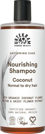 White bottle of Urtekram Nourishing Coconut Shampoo with a black cap, featuring brown text and botanical illustrations.