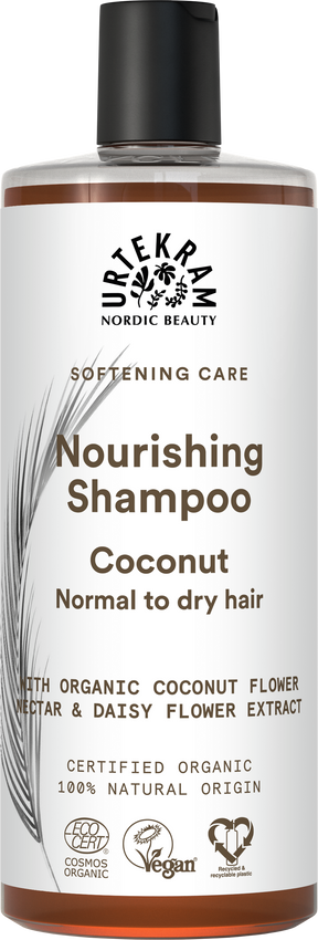 White bottle of Urtekram Nourishing Coconut Shampoo with a black cap, featuring brown text and botanical illustrations.