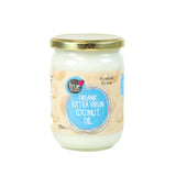 A 500ml glass jar of solid white True Organic Extra Virgin Coconut Oil with a light beige label, blue circular branding, and a gold metal lid.