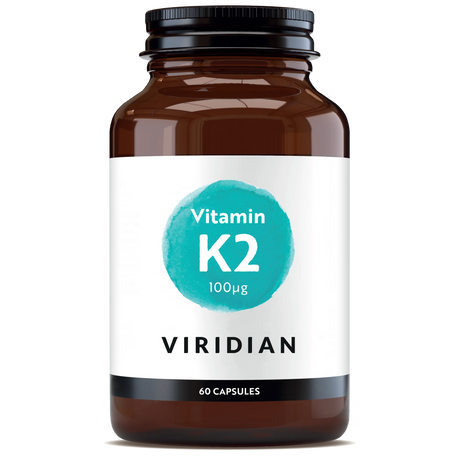 A 60-capsule amber glass jar of Viridian Vitamin K2 100µg food supplement with a white label and a turquoise watercolor-style circle, isolated on a white background.