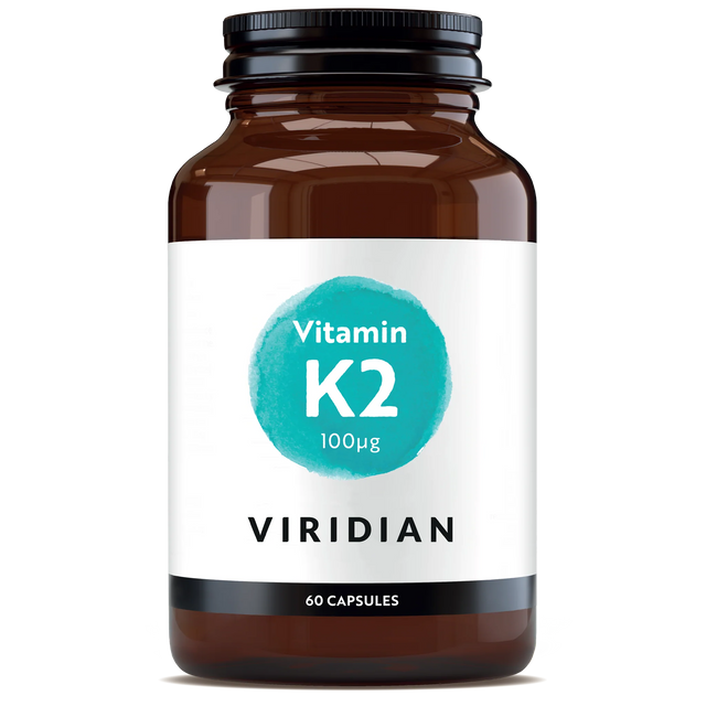 A 60-capsule amber glass jar of Viridian Vitamin K2 100µg food supplement with a white label and a turquoise watercolor-style circle, isolated on a white background.