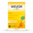 A yellow box of Weleda Calendula Soap, described as a plant-based cleanser for delicate skin, featuring orange calendula flower illustrations.