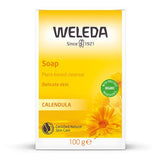 A yellow box of Weleda Calendula Soap, described as a plant-based cleanser for delicate skin, featuring orange calendula flower illustrations.