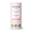 A light pink tube of Weleda Deodorant Stick for sensitive skin, featuring "24h protection" and "no alcohol" labels with organic certification icons at the base.