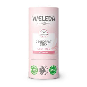 A light pink tube of Weleda Deodorant Stick for sensitive skin, featuring "24h protection" and "no alcohol" labels with organic certification icons at the base.
