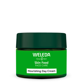 A green jar of Weleda Skin Food Nourishing Day Cream with a dark green lid and a white label strip at the bottom.