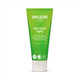 A bright green tube of Weleda Skin Food Light, labeled as intensive, instant moisturising skin care for face or body, specifically for dry skin.