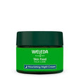 A green jar of Weleda Skin Food Nourishing Night Cream with a dark green lid and a blue label featuring a crescent moon icon.