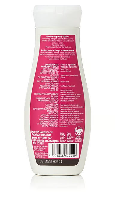 The back of a white Weleda body lotion bottle showing a pink label with a detailed list of ingredients, including wild rose oil and shea butter, and manufacturing information for the Wild Rose Pampering Body Lotion.