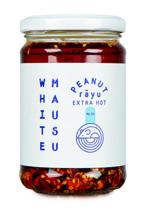 Glass jar of White Mausu Extra Hot Peanut Rayu featuring a white label with blue text.