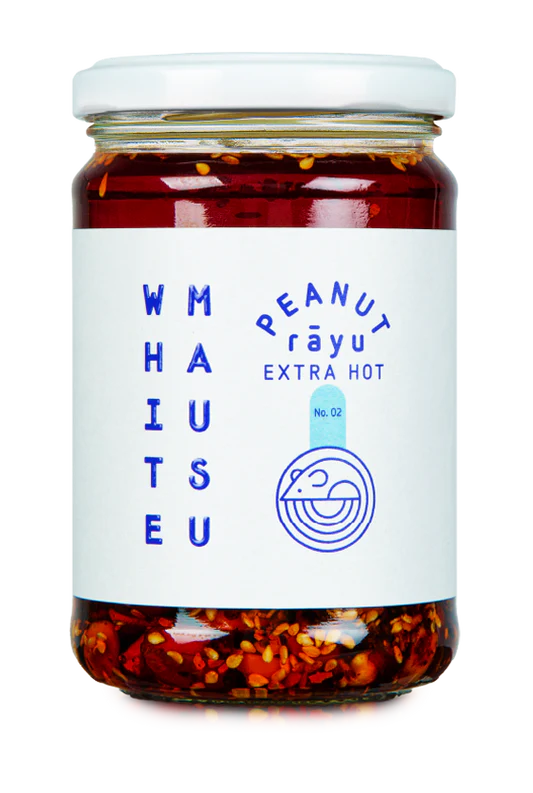 Glass jar of White Mausu Extra Hot Peanut Rayu featuring a white label with blue text.