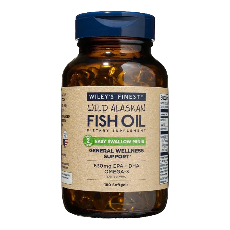 An amber glass bottle of Wiley's Finest Wild Alaskan Fish Oil "Easy Swallow Minis" dietary supplement, containing 180 softgels for general wellness support, featuring a blue flip-top cap and a tan label stating 630mg EPA + DHA per serving.