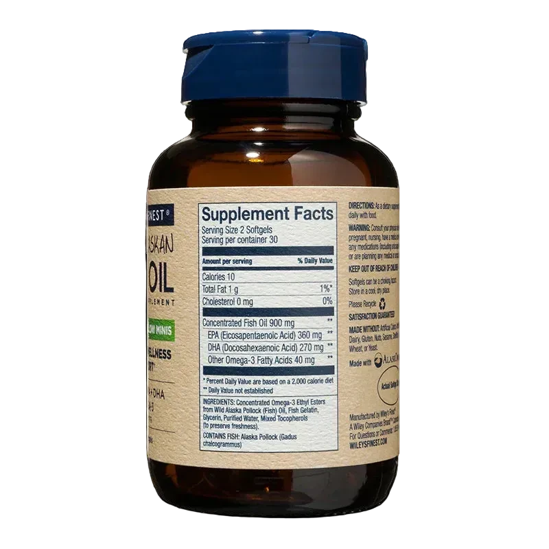 A side-angle view of an amber glass bottle of Wiley's Finest Easy Swallow Minis fish oil, displaying the "Supplement Facts" panel for a 30-day supply (serving size 2 softgels) on a tan label with a blue flip-top cap.